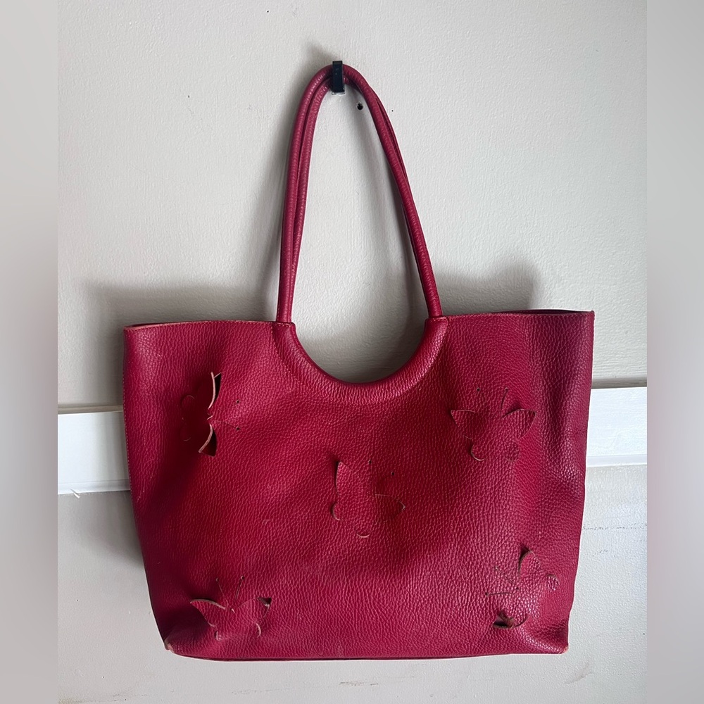 Claudia Firenze red leather tote bag featuring butterfly cutout design.